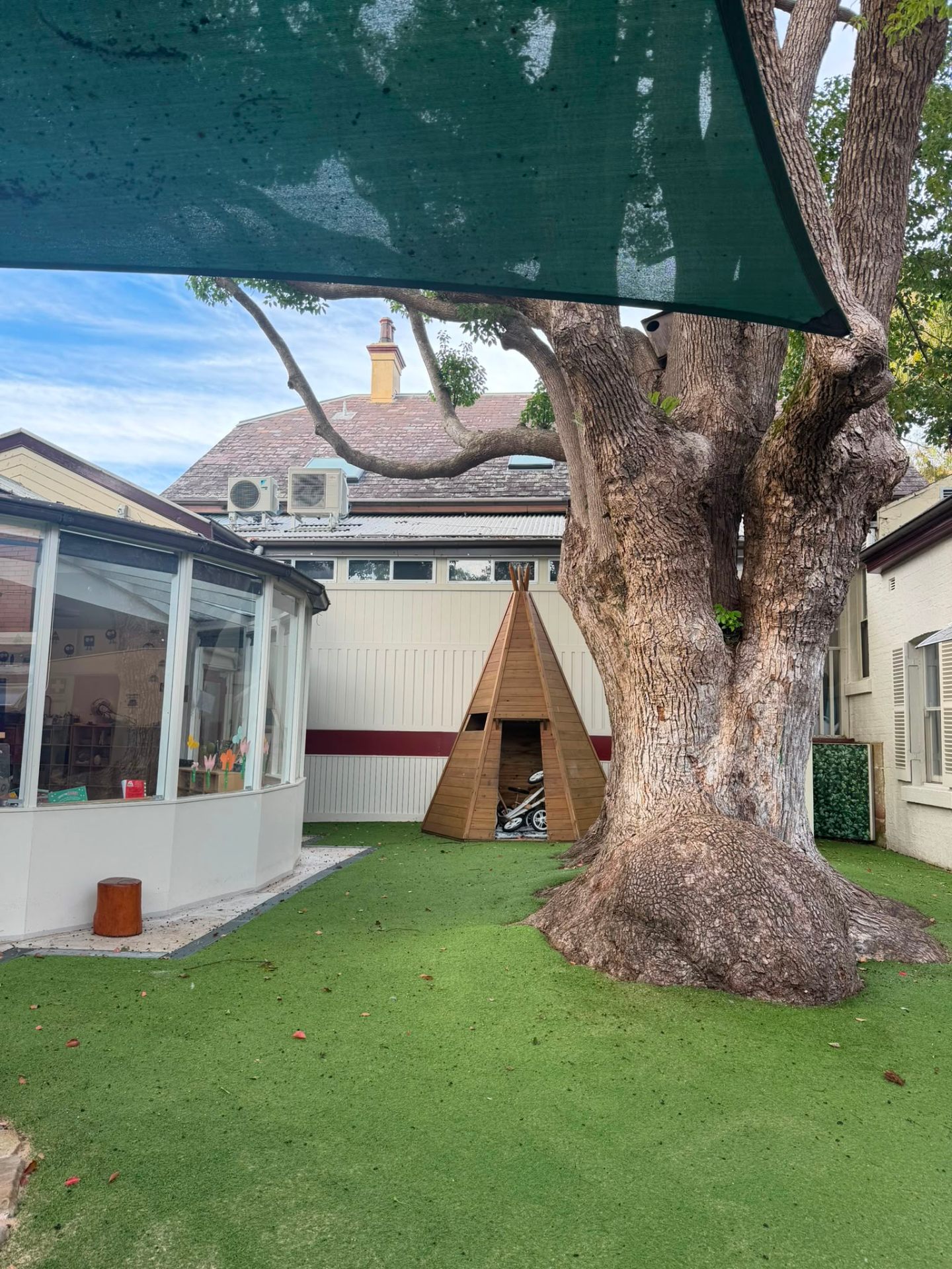 Our leafy Glebe outdoor play area with heritage tree and cubby